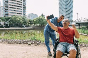 man-in-wheelchair-taking-selfie-with-his-caretaker-2023-11-27-05-23-12-utc-300x200