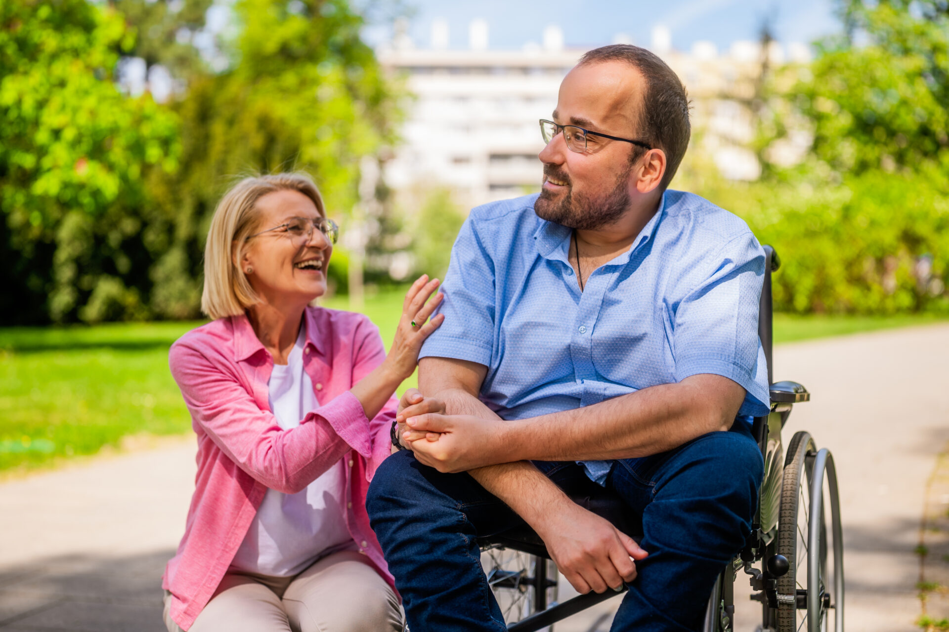 Man in a wheelchair receiving personal assistance from a friend in Melbourne, highlighting NDIS support services