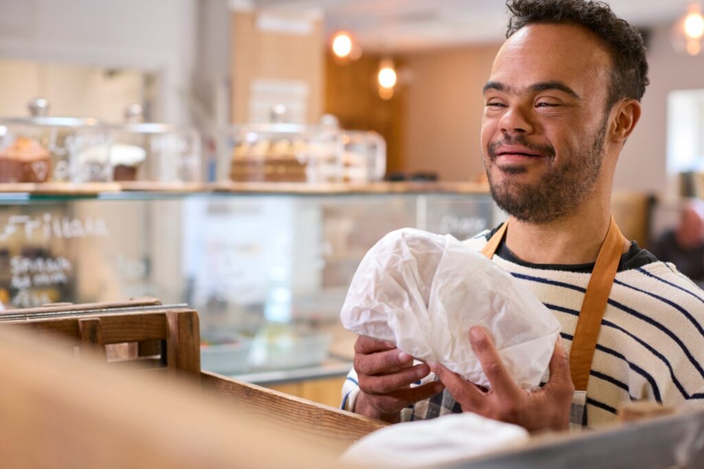 Man working in a café, showcasing No Limits Care's focus on Supported Independent Living Melbourne.