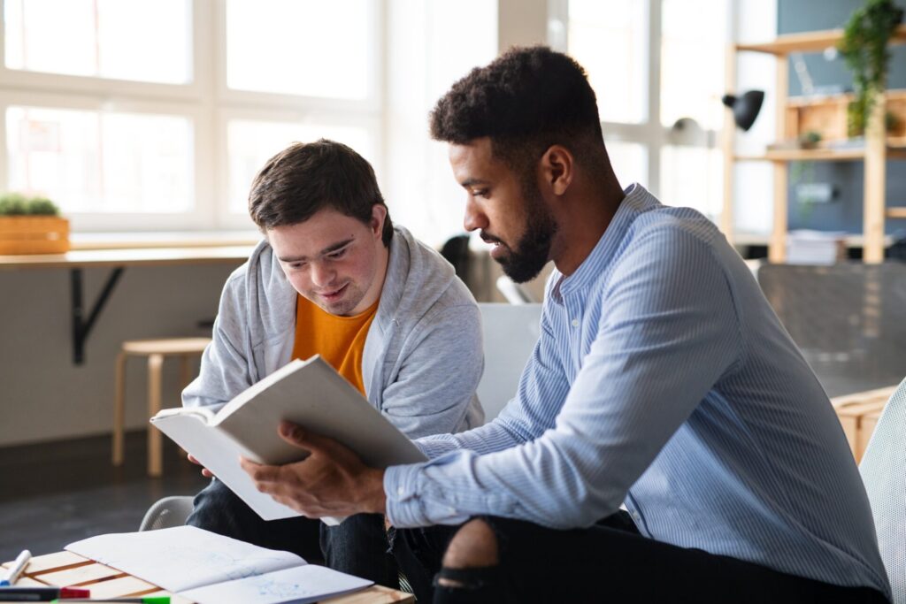 Two men collaborating in an office, highlighting No Limits Care's Supported Independent Living Melbourne services.